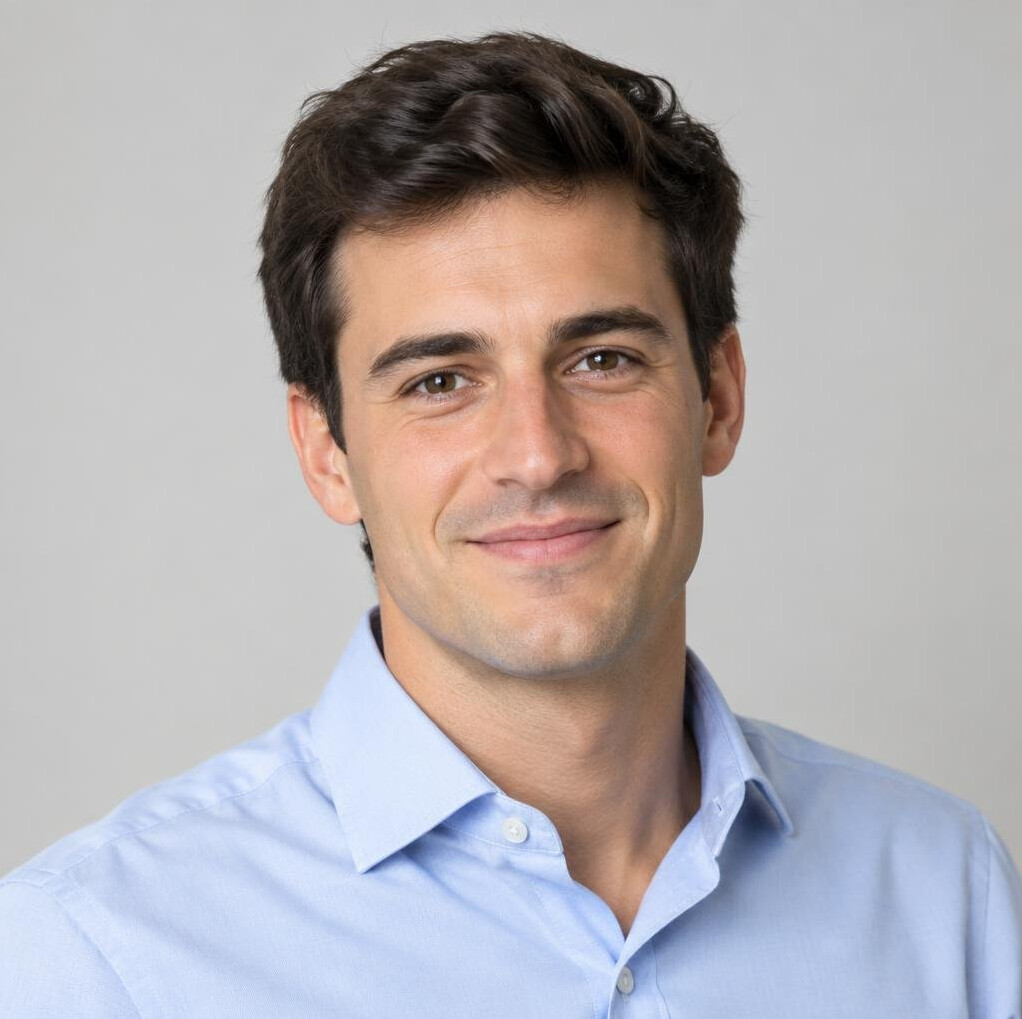 Portrait of a man with dark hair and a light shirt